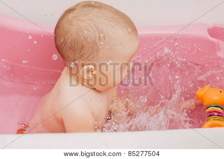 child bathes in a bathtub