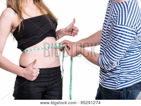 Young Man Measuring Woman's Waist