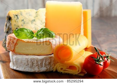 Different Sorts Of Cheese Isolated On Kitchen Table
