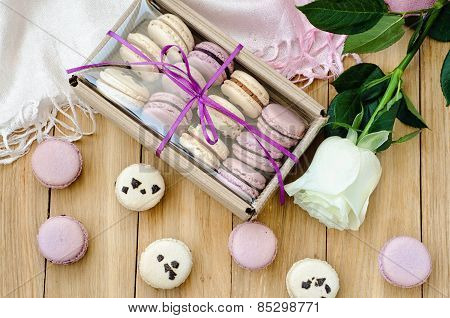 Lilac macaroons with rose and gift box. top view