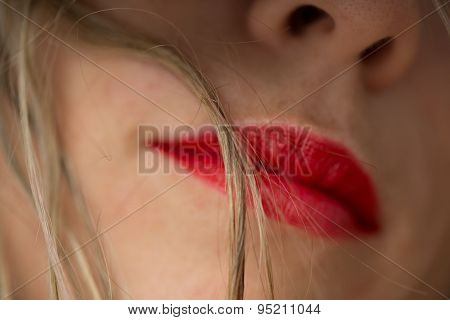 Beautiful woman's red lips and blonde hair