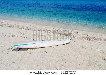 Surfboard On A White Beach