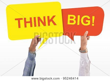 Two speech bubbles in hand with the word think big mentioned