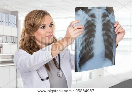 Female Doctor Looking At A Lungs Or Torso Xray