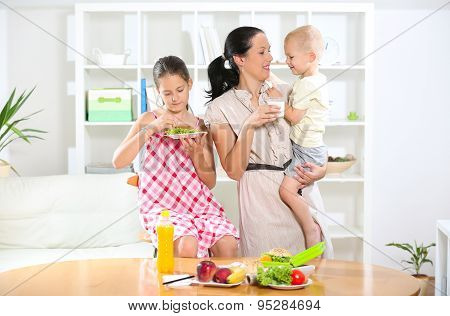 Mother making breakfast for her children in the morning and a snack for school
