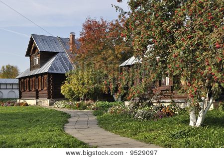 Beautiful Wooden House With Rowan-trees In Autumn