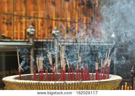 Lighted Candle And Incense For Buddha. Selective Focus.