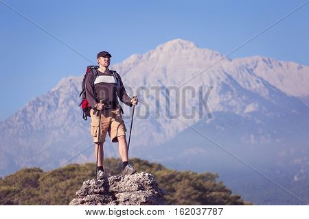 Summer hiking in the mountains with a backpack .