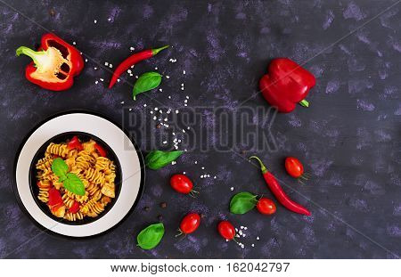 Radiatori Pasta With Chicken And Peppers On Dark Background. Top View
