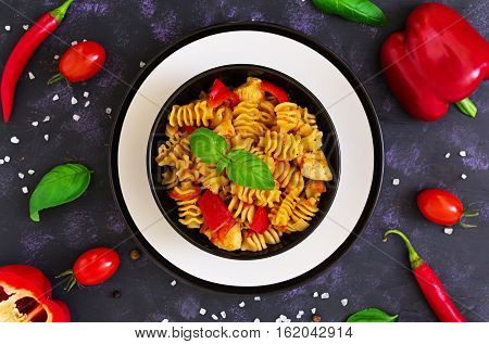 Radiatori Pasta With Chicken And Peppers On Dark Background. Top View
