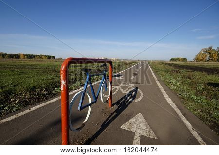 bicycle track in the summer on the nature between the field and forest