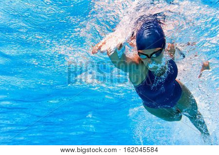 Underwater image of swimmer in action, toned image, horizontal image