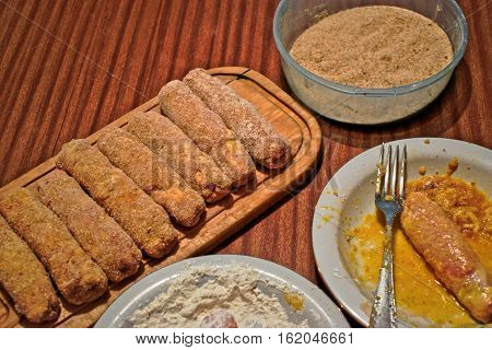 Making stuffed Karadjordje schnitzels on a table