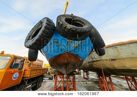 MOSCOW, RUSSIA - NOVEMBER 11, 2016: State Unitary Enterprise Mosvodostok performs recovery vessels on coastal winter parking. Ship mounted on metal supports.
