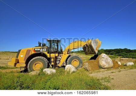 HAWLEY, MINNESOTA, August 4, 2016; Founded in 1925, the 982 M Cat carrying sand is from Caterpillar Inc., an American corporation which designs, develops, engineers, manufactures, markets and sells machinery, engines, financial products and insurance