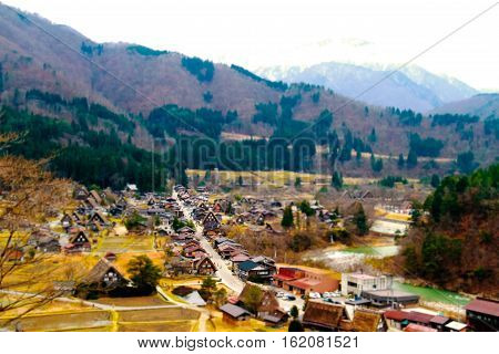 tilt shift blur effect small people walking at japanese village Shirakawa-go located in Gifu Prefecture. Traditional village Japan's UNESCO World Heritage