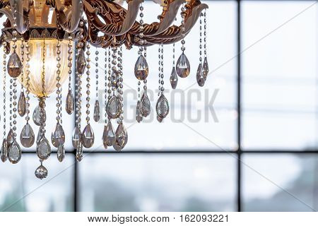 beautiful crystal chandelier close-up shot with brightness background and copy space.