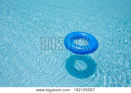 blue swim ring for children float on swimming pool isolated