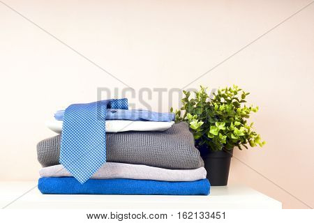 stack of clothing isolated on white sweaters Shirts knitwear space for text
