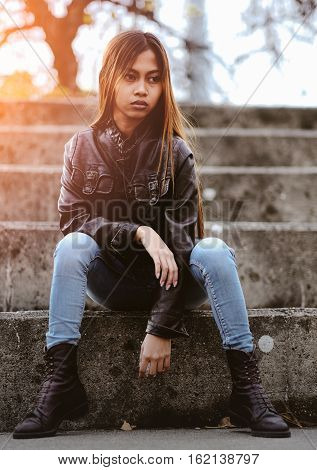 Asian hipster girl with fashionable brown leather jacket