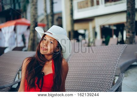 Beautiful asian girl with a hat on vacation