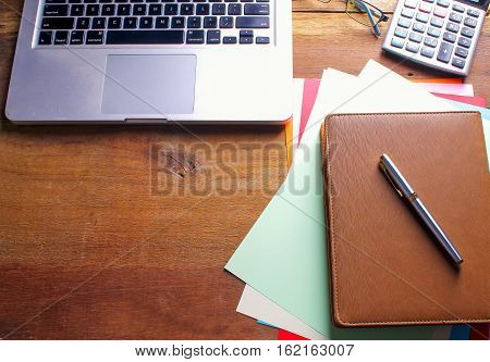 Office workplace with laptop and smart phone on wood table