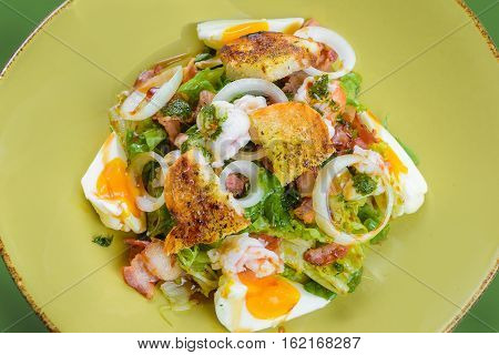 Korean salad with egg and seafood in green dish