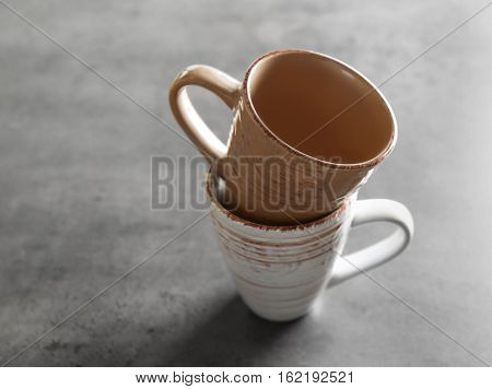 Two cups on gray background