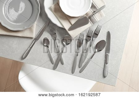 Cutlery set with plates on gray table,top view