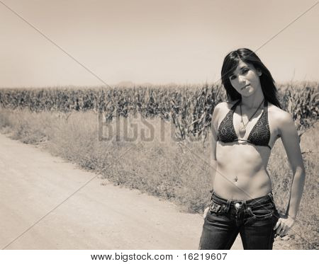 Young woman posing in the wild west of Arizona in soft sepia tone