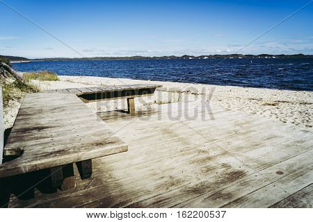 Bench on Coalmine Beach Walpole Australia . vintage toning filter add .