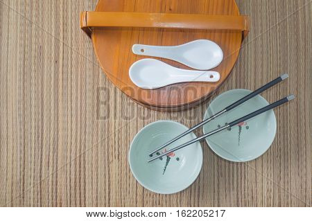 Chinese lunch box with a bowl and chopsticks top view
