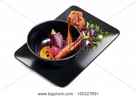 Molecular Cuisine. Delicious modern soup with beetroot. Isolated on white. Stock image.