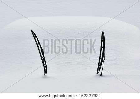 Two windscreen wipers poking out of a blanket of snow