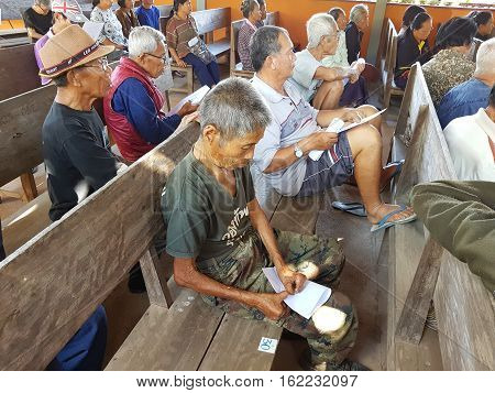 CHIANG RAI THAILAND - DECEMBER 19 : Unidentified asian old people suffering from leprosy reading and waiting for treatment on December 19 2016 in Chiang rai Thailand.