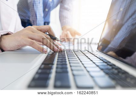 Team work process. young business managers crew working with new startup project. labtop on wood table typing keyboard texting message analyze graph plans