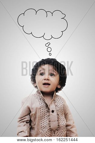 Adorable Intelligent Little Boy Thinking Cloud While Standing Before A White Background; Thinking Process With Chalk Board