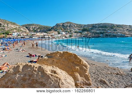 MATALA CRETE GREECE - JULY 25 2011: Many people having fun in a beach at Matala village