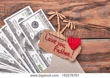 Dollars and pyrography palm trees. Fabric heart and greeting card. Travelling is the best investment.