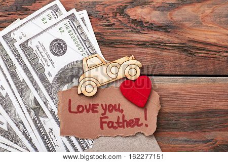 Money, pyrography car, greeting card. Fabric heart on envelope. Life is motion.