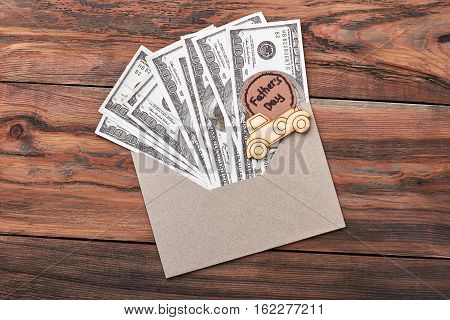 Greeting card and dollars. Envelope and pyrography car. The most useful gift.