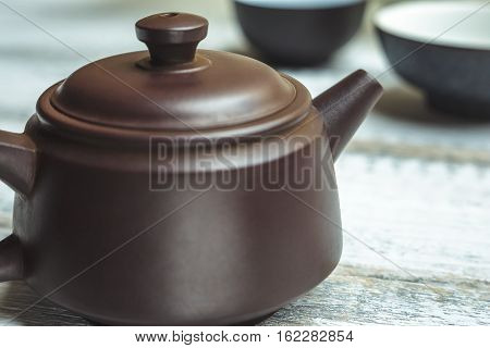 Traditional Teapot from Yixing clay for Chinese tea ceremony on rustic wooden background Close up image