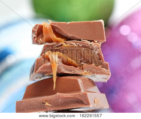 picture of a chopped chocolate piesec with caramel fill , macro, studio shot