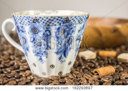 Coffee Cup and coffee beans on wooden table background beautiful, vintage blue color tone