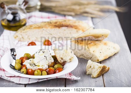 Italian focaccia bread with olives and basil