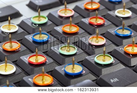 Pins on computer keyboard - concept background