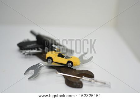 Abstract composition of broken car and repair process.