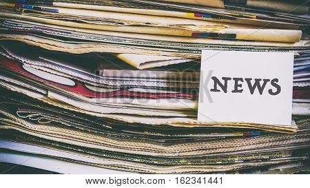 A Stack Of Old Newspapers, Words On A Paper Sticker