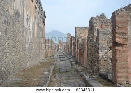 Residential street in Pompeii Italy with Mt Vesuvius in the back