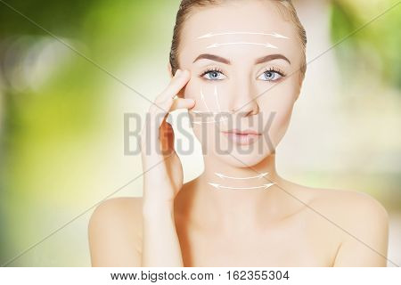 beautiful young woman face with lifting marks for surgeon